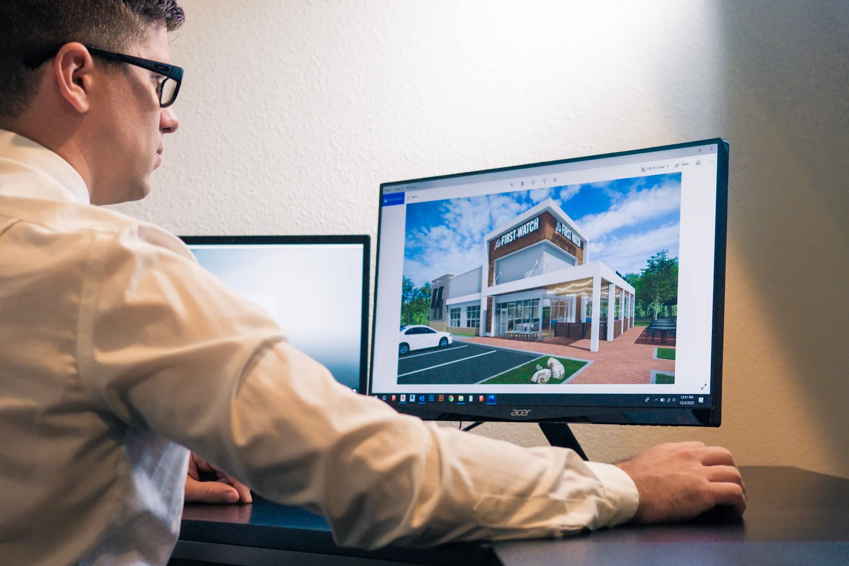 Freelancer working on a custom 3D gallery design on a laptop